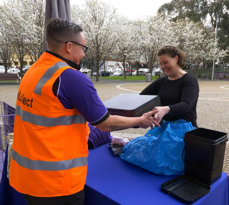ANZRP TechCollect staff collecting electronic waste at an outdoor e‑waste disposal event.