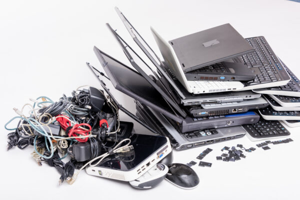 E‑waste recycling solutions showing laptops, cables and electronic devices ready for responsible processing